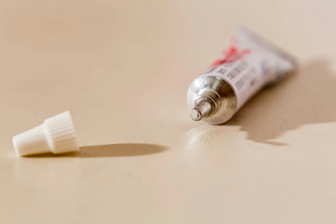 white tube bottle on white table