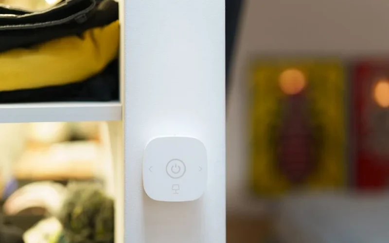 Close-up of a smart home light switch in a modern room interior, showcasing contemporary technology.