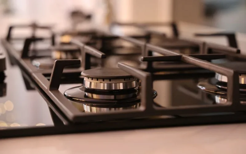 Close-up of a modern stainless steel gas stove top, ideal for contemporary kitchens and cooking environments.