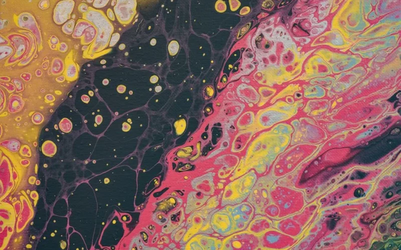 Vibrant fluid art painting with bold colors and organic patterns, showcasing dynamic acrylic pour techniques.