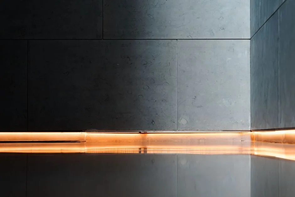 Modern interior showcasing sleek walls, reflective flooring, and ambient lighting for a serene atmosphere.