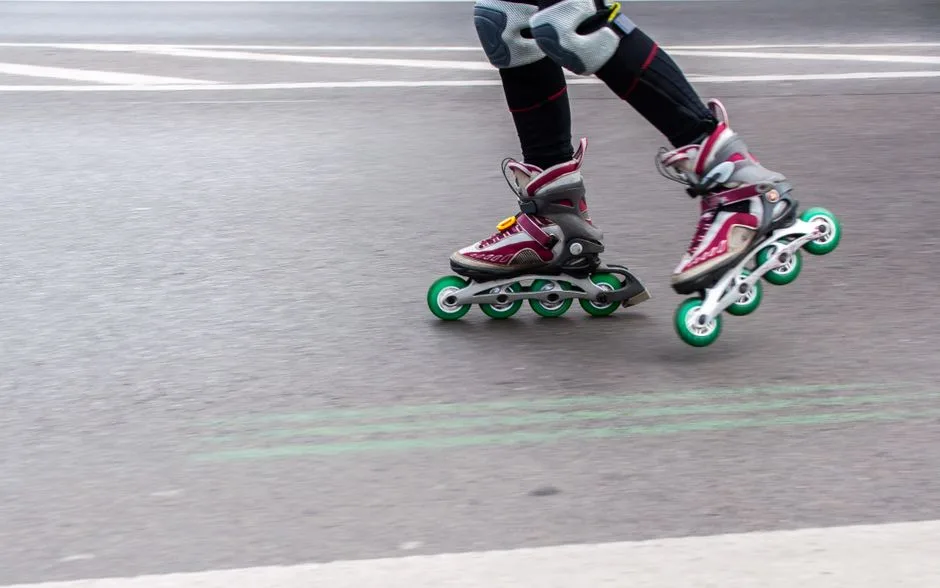 Close-up of a person rollerblading on an urban street, showcasing speed and motion.