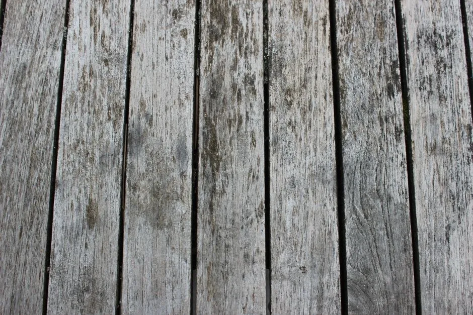 Close-up of weathered wooden planks with visible grain and texture, ideal for design backgrounds.