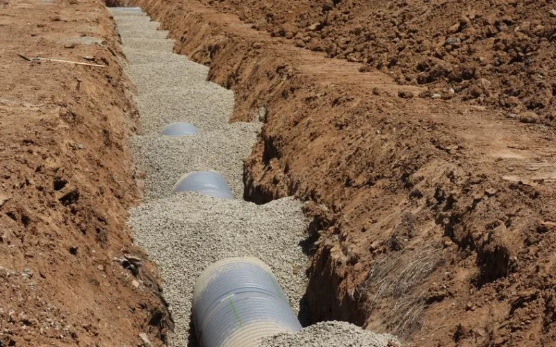Detailed view of drainage pipe construction in a trench, Elk Grove, California.