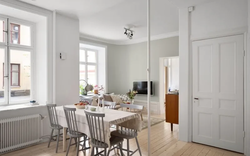 Spacious Scandinavian-style living and dining area with minimalist decor and natural light.