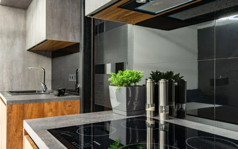 Contemporary kitchen interior featuring a stylish induction cooktop, stainless steel fixtures, and minimalist design.
