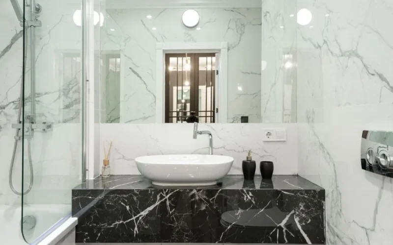 Elegant marble bathroom featuring modern sink and fixtures.