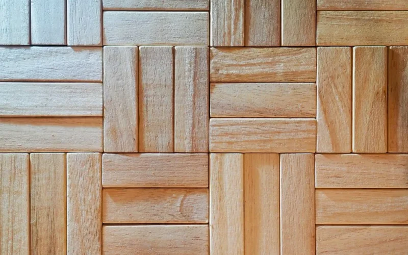 Close-up of intricately patterned wooden parquet with a natural texture and light finish.