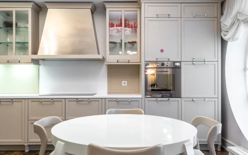 Contemporary kitchen with sleek cabinets and a round dining table.