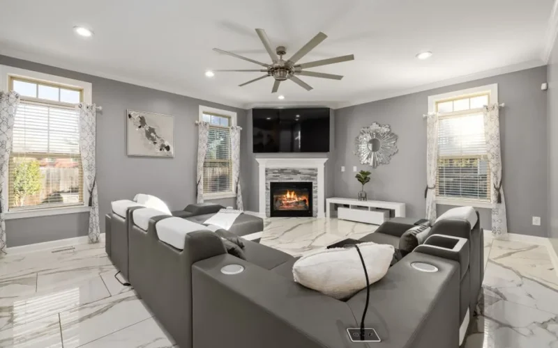 Contemporary living room featuring sleek furniture, a fireplace, and elegant decor.