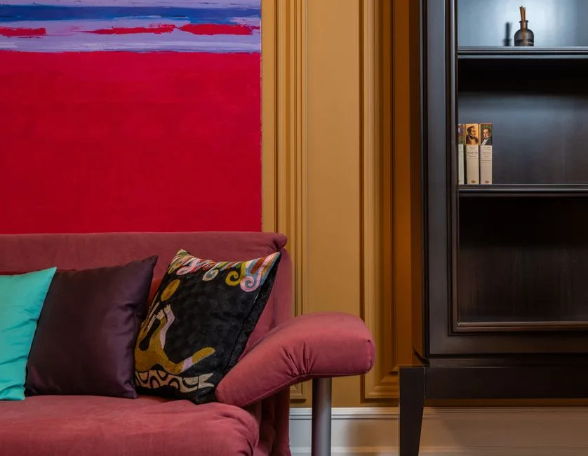 Elegant living room with a vibrant painting, plush sofa, and stylish decor. Perfect for luxury interior design inspiration.